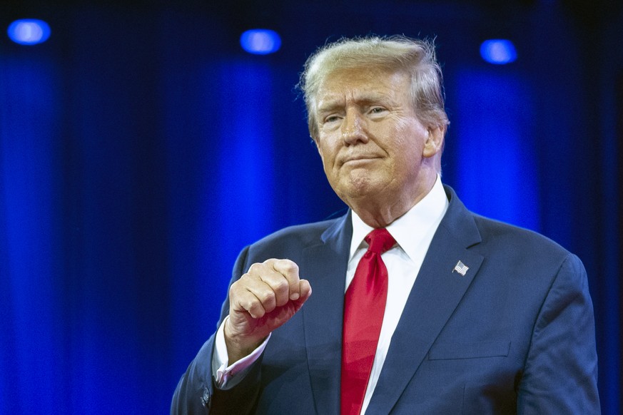 FILE - Republican presidential candidate former President Donald Trump pumps his fist as he departs after speaking during the Conservative Political Action Conference, CPAC 2024, at National Harbor, i ...