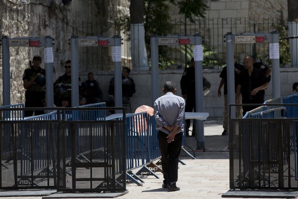 A Palestinian man walks towards a metal detector at the Al Aqsa Mosque compound in Jerusalem's Old City, Wednesday, July 19, 2017. A dispute over metal detectors has escalated into a new showdown betw ...