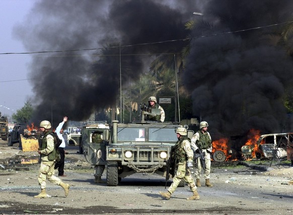 U.S. troops secure the area after explosives went off in Baghdad&#039;s Palestine street Wednesday, Dec. 31 2003. At least two people were reported injured in the blasts. (AP Photo/Hadi Mizban)