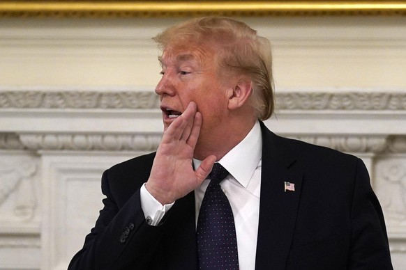 President Donald Trump gestures as he leaves a meeting with restaurant industry executives about the coronavirus response, in the State Dining Room of the White House, Monday, May 18, 2020, in Washing ...