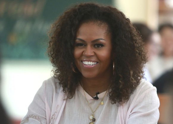FILE - In this Dec. 9, 2019, file photo, Michelle Obama listens to female students at the Can Giuoc high school in Long An province, Vietnam. Higher Ground--a production company founded by Barack and  ...
