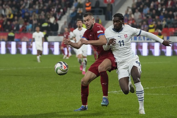 Serbia&#039;s Strahinja Pavlovic, left, and Switzerland&#039;s Joel Monteiro fight for the ball during the UEFA Nations League soccer match between Serbia and Switzerland at the Dubocica Stadium in Le ...