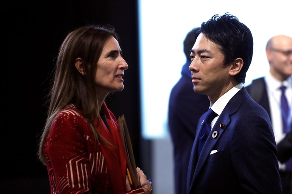 epa08072787 Chilean Environment Minister and President of COP25 Carolina Schmidt (L) speaks with a member of the Japanese delegation prior a new plenary session of the COP25 UN Climate Change Conferen ...