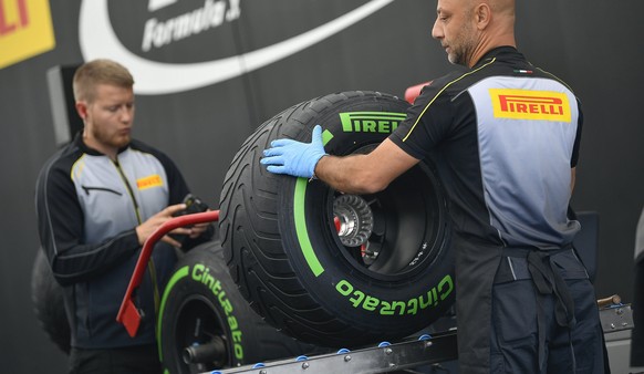 epa06112391 Pirelli mechanics work on formula one tyres in the paddock at the Hungaroring racetrack near Budapest, Hungary, 27 July 2017. The Hungarian Formula One Grand Prix will be held on 30 July.  ...