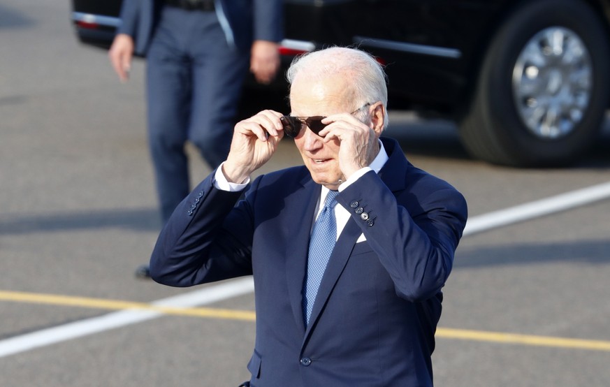 epa10738293 US President Joe Biden adjust his glasses after he arrived at Vilnius Airport on the eve of a NATO summit, in Vilnius, Lithuania, 10 July 2023. The NATO Summit will take place in Vilnius o ...