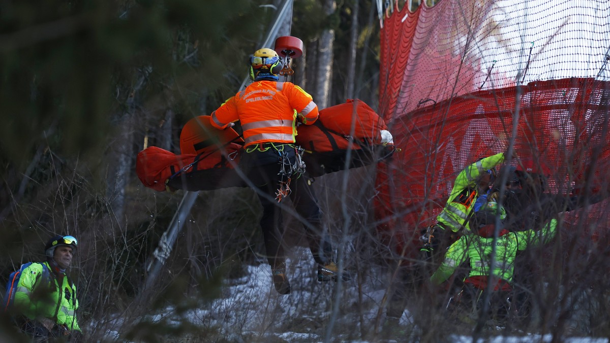 Medical staff are carrying France's Cyprien Sarrazin after crashing into protections net during an alpine ski, men's World Cup downhill training, in Bormio, Italy, Friday, Dec. 27, 2024. (AP ...