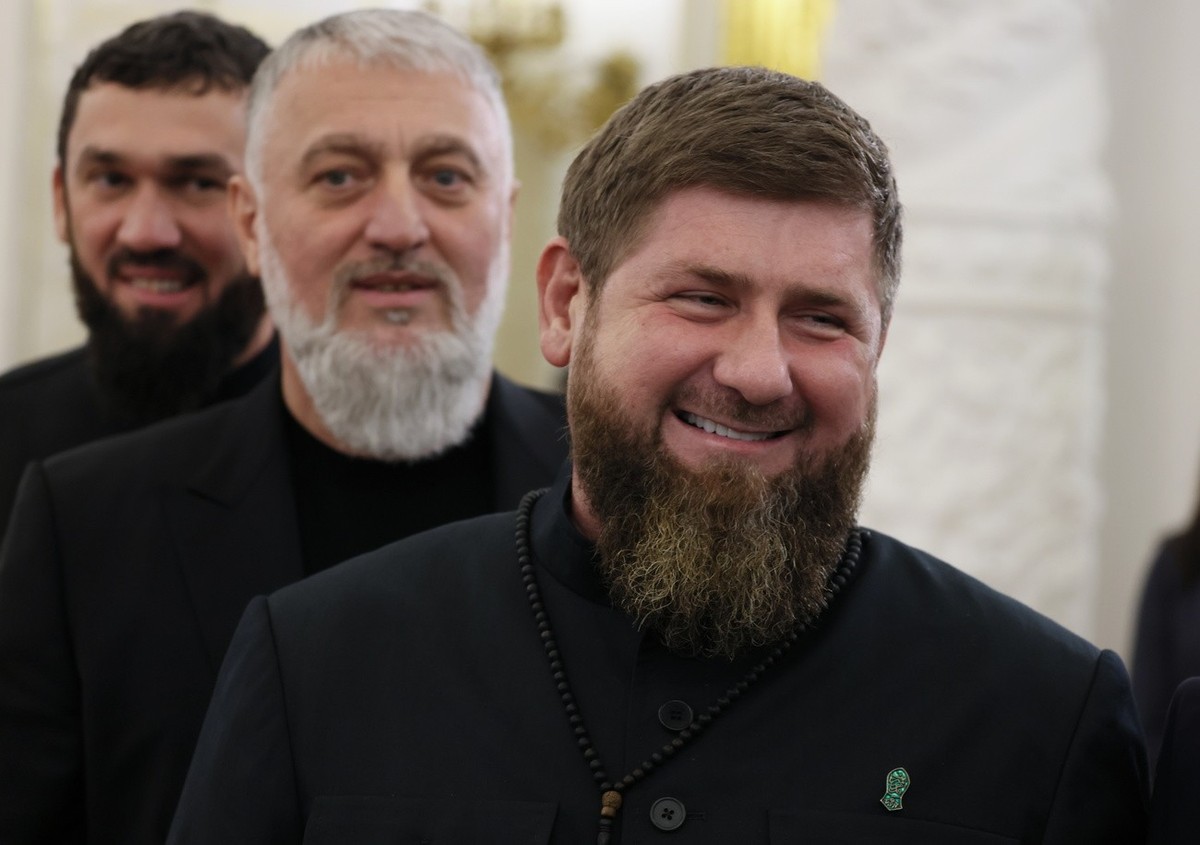 epa10215718 Chechnya's regional President Ramzan Kadyrov (R), Russian State Duma member Adam Delimkhanov (C) and Chechen Parliament Chairman Magomed Daudov (L) arrive for a ceremony to sign treat ...