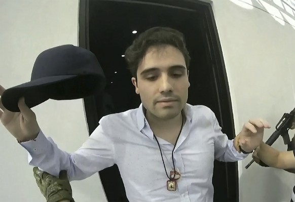 FILE - This frame grab from video, provided by the Mexican government, shows Ovidio Guzman Lopez being detained in Culiacan, Mexico, Oct. 17, 2019. (CEPROPIE via AP File)
Mexico Sinaloa Cartel