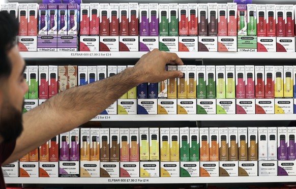 epa11568678 A person picks up a vape from a shelf at a store in London, Britain, 28 August 2024. The British Medical Association (BMA) urged the British government on 28 August to stop a &#039;growing ...
