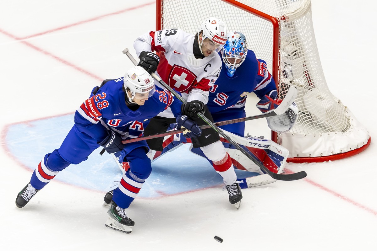epa12094471 USA's Zeev Buium (L) and goaltender Joey Daccord (R) in action against Switzerland's Nico Hischier (C) during the IIHF 2025 World Championship preliminary round group B ice hocke ...
