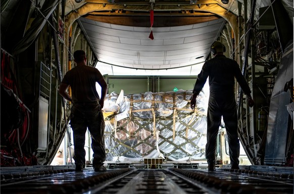 This photo provided by U.S. Air Force, U.S. Air Force loadmasters assigned to the 36th Airlift Squadron prepare to offload a pallet of cargo from a C-130J Super Hercules from the 36 AS in Saipan, Comm ...