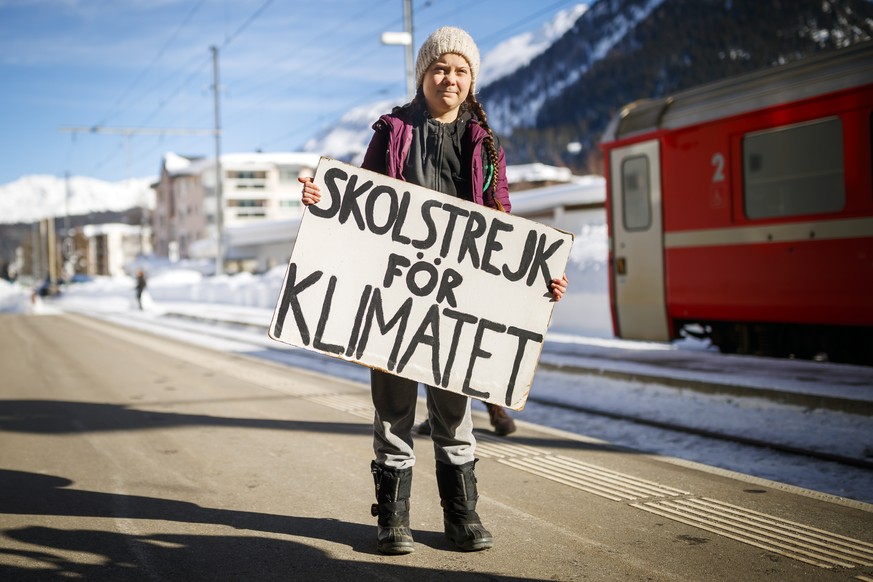 epa07311574 Swedish climate activist Greta Thunberg, 16, holds a banner reading &#039;School strike for the climate&#039; as she arrives to attend the 49th Annual Meeting of the World Economic Forum ( ...