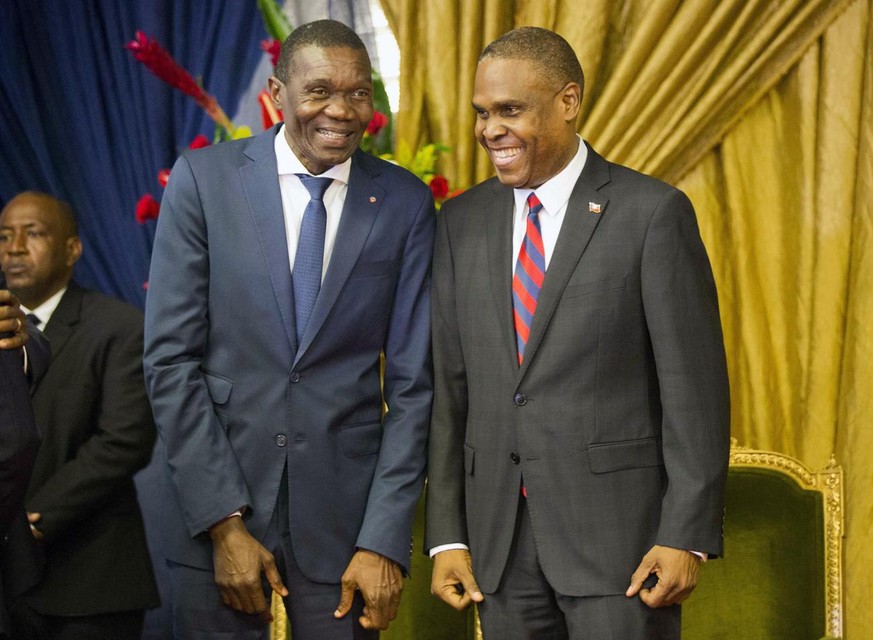 Haiti&#039;s new prime minister Jean-Henry Ceant, right, talks to Senate President Joseph Lambert during the nomination ceremony at the national Palace in Port-au-Prince, Haiti, Tuesday, Aug. 7, 2018. ...