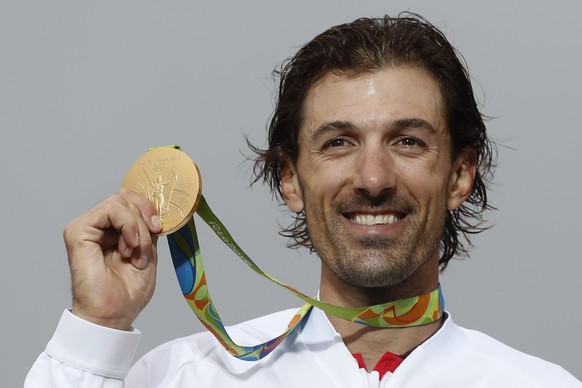 Cyclist Fabian Cancellara of Switzerland holds his gold medal during the podium ceremony of the men's individual time trial event at the 2016 Summer Olympics in Pontal beach, Rio de Janeiro, Brazil, W ...