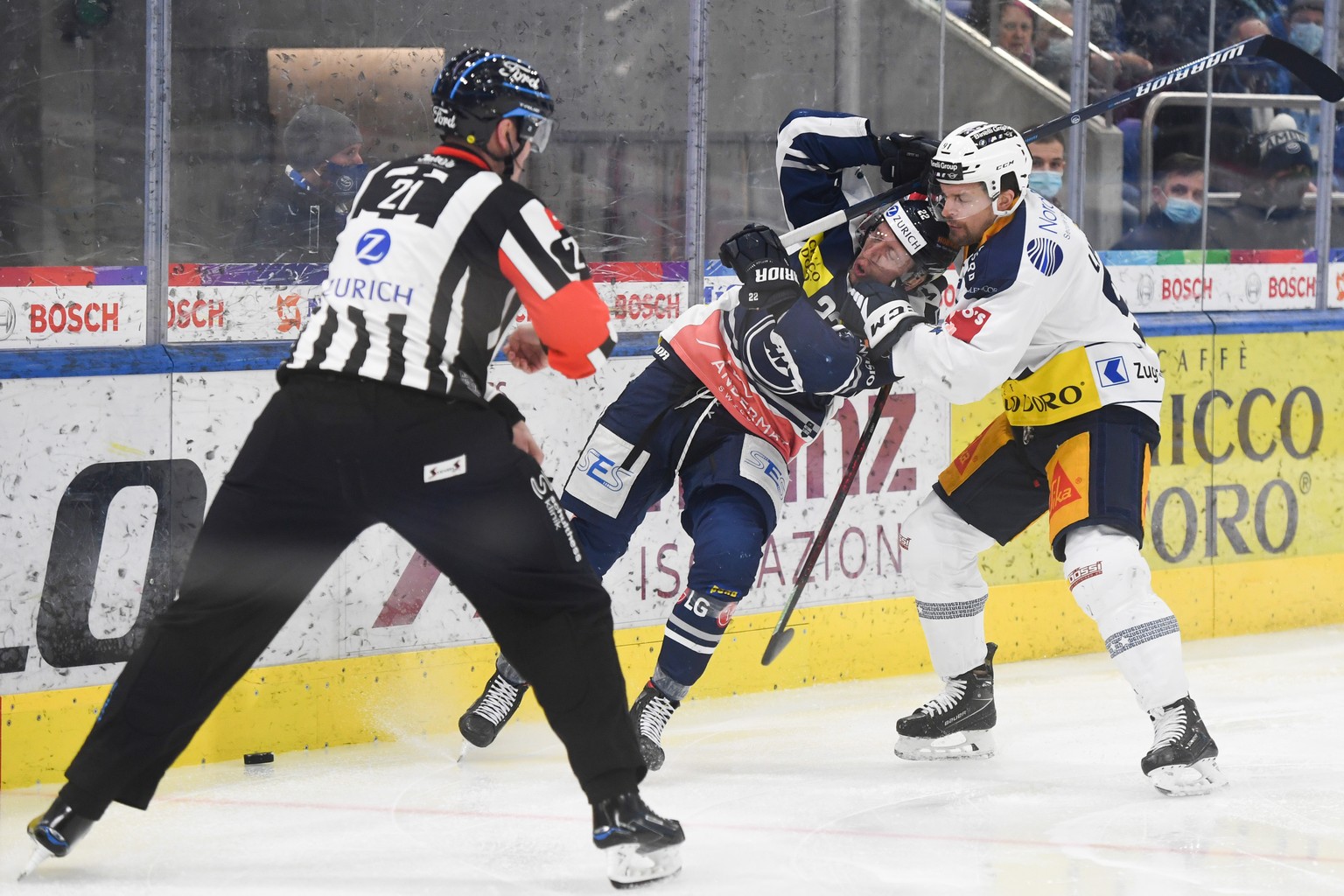 From left, Ambri&#039;s player Diego Kostner and Zug&#039;s player Anton Lander, during the match of National League A (NLA) Swiss Championship 2021/22 between HC Ambri Piotta and EV Zug at the ice st ...