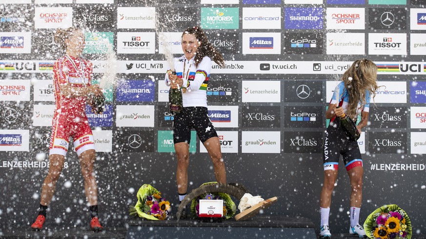 epa07005354 (L-R) Silver medalist, Annika Langvad of Denmark, Gold medalist Kate Courtney of the USA and bronze medalist Emily Batty of Canada celebrate on the podium after the women&#039;s elite cros ...