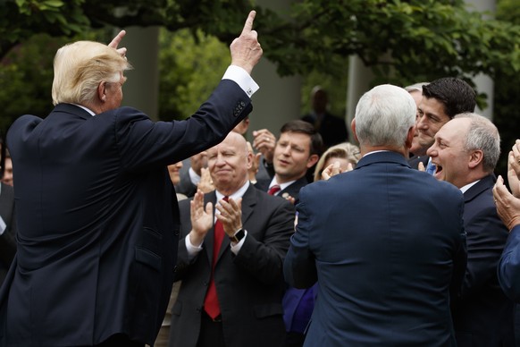 President Donald Trump pumps his hands to GOP House members after the House pushed through a health care bill, in the Rose Garden of the White House, Thursday, May 4, 2017, in Washington. (AP Photo/Ev ...