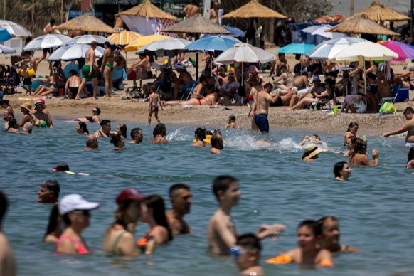 People enjoy the sea as temperatures reached 39 Celsius degrees, ( 102.2 Fahrenheit), at Glyfada suburb, south of Athens, Greece, on Sunday July 19, 2026. (AP Photo/Yorgos Karahalis)
Greece Extreme We ...