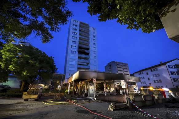 Firefighters continue to work at the scene after an explosion in an underground car park and a subsequent fire in a high-rise building at Markthof Nussbaumen, in Nussbaumen, Switzerland,late Thursday, ...