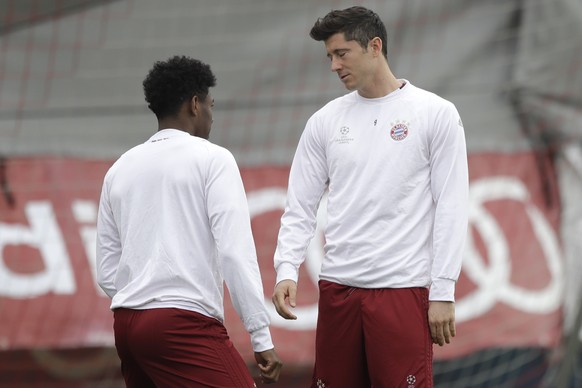 Bayern&#039;s Robert Lewandowski, right, closes his eyes besides team mate David Alaba during a training session prior to the Champions League quarterfinal first leg soccer match between FC Bayern Mun ...