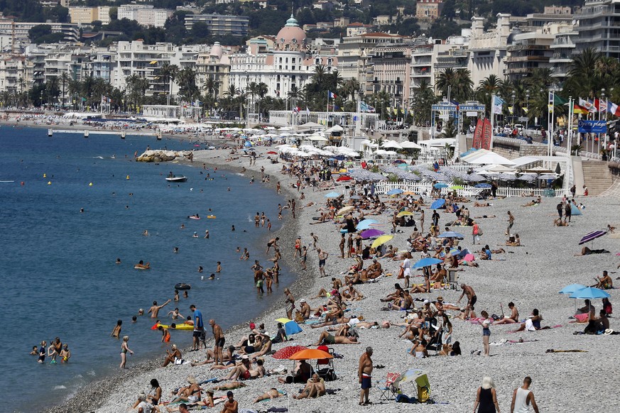 epa08536601 People enjoy the sun and the sea on a beach in Nice, southern France, 09 July 2020. Temperatures reached up to 30 degrees Celsius in Nice. EPA/SEBASTIEN NOGIER