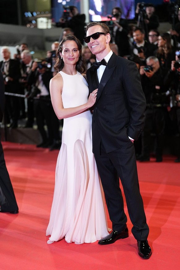 Alicia Vikander, left, and Michael Fassbender pose for photographers upon arrival at the premiere of the film 'Hope' at the 79th international film festival, Cannes, southern France, Sunday, ...
