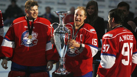 Ari Sulander, Mathias Seger and Adrian Wichser, from left, of Swiss team ZSC Lions lift the trophy after winning the ice hockey Champions League final match against Metallurg Magnitogorsk in Rapperswi ...