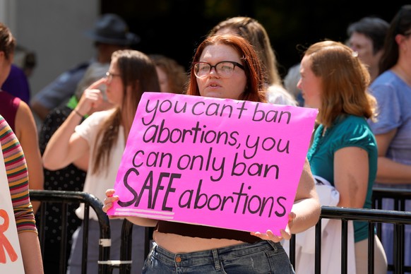 An abortion-rights supporter holds a sign outside the South Carolina Statehouse on Thursday, July 7, 2022, in Columbia, S.C. Protesters clashed outside a legislative building, where lawmakers were tak ...