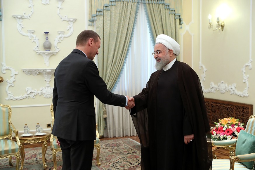 epa07707957 A handout photo made available by the presidential office shows Iranian president Hassan Rouhani (R) meeting with French envoy Emmanuel Bonne (L) in Tehran, Iran, 10 July 2019. French Pres ...