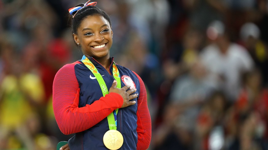 2016 Rio Olympics - Artistic Gymnastics - Final - Women&#039;s Floor Final - Rio Olympic Arena - Rio de Janeiro, Brazil - 16/08/2016. Gold medalist Simone Biles (USA) of USA places her hand on her hea ...