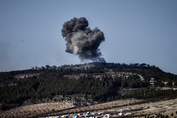 FILE - In this Jan. 28, 2018 file photo, a plume of smoke rises from inside Syria, during Turkish forces bombardment, on the Kurdish-controlled enclave of Afrin, Syria, as seen from the border with Sy ...