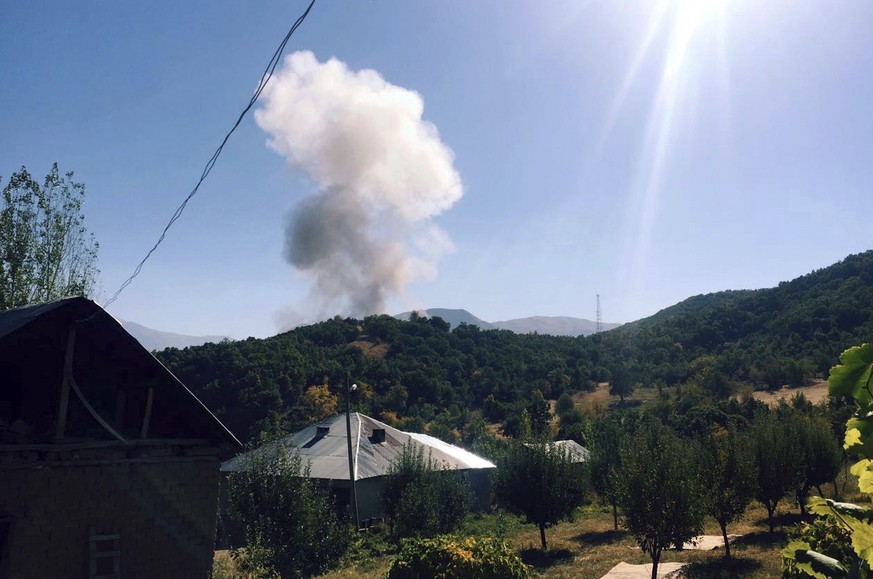 Smokes rise after Kurdish militants detonated a car bomb outside a military station in Semdinli near the border with Iraq, Turkey, Sunday, Oct. 9, 2016. The Anadolu Agency, citing a statement by the T ...