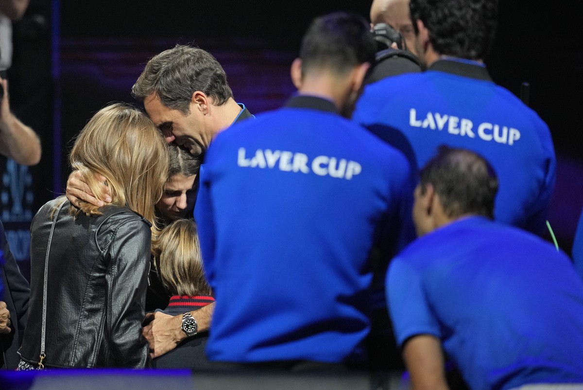 An emotional Roger Federer of Team Europe embraces his wife Mirka and their children after playing with Rafael Nadal in a Laver Cup doubles match against Team World's Jack Sock and Frances Tiafoe ...