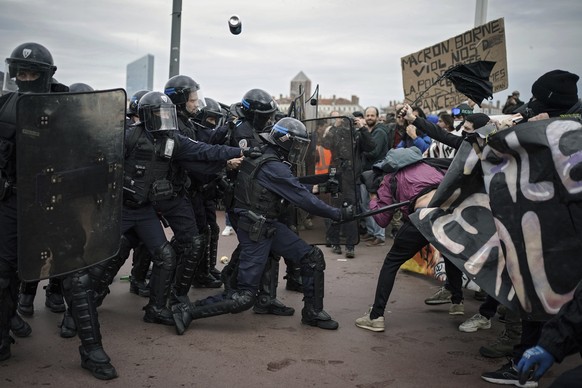 Protesters clash with police officers during a demonstration in Lyon, central France, Thursday, March 23, 2023. French unions are holding their first mass demonstrations Thursday since President Emman ...