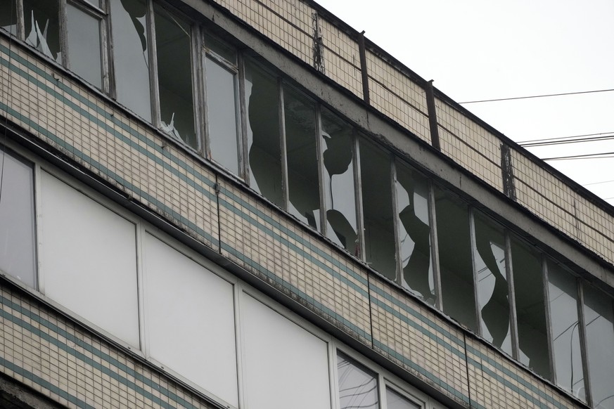 Broken windows are seen after Russian shelling in Kyiv, Ukraine, Thursday, Feb. 24, 2022. Russian troops have launched their anticipated attack on Ukraine. Big explosions were heard before dawn in Kyi ...