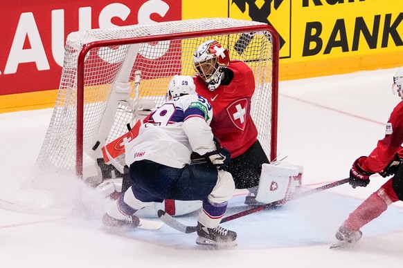 HELSINKI, FINLAND - MAY 26: Ben Meyers of United States (L) scores his goal against goalkeeper Leonardo Genoni of Switzerland (R) during the 2022 IIHF Ice Hockey World Championship match between Switz ...