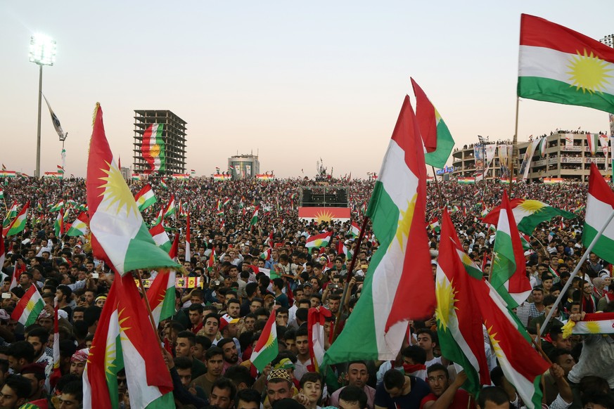 epa06220465 Kurds hold Kurdish flags as they take part part in a rally for the Kurdistan independence referendum campaign at the Franso Hariri stadium in Erbil, Iraq, 22 September 2017. Kurdish leader ...