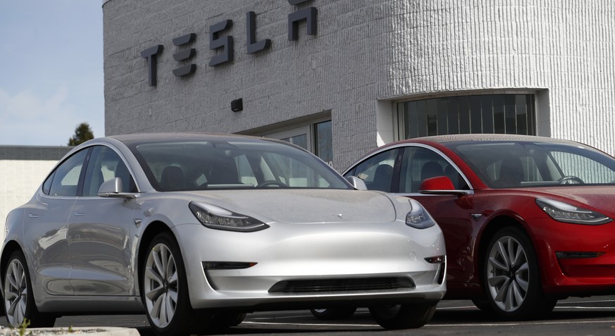 In this Sunday, April 15, 2018, photograph, unsold 2018 Model 3 Long Range vehicles sit on a Tesla dealer&#039;s lot in the south Denver suburb of Littleton, Colo. (AP Photo/David Zalubowski)