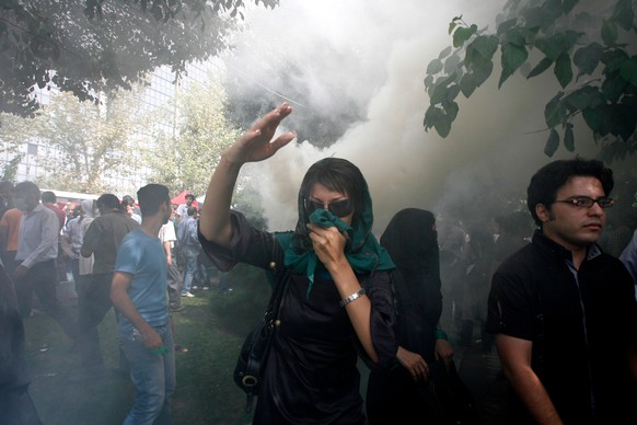 FILE - An Iranian female opposition supporter reacts as she attends a protest in Tehran, Iran, Friday, Sept. 18, 2009, in competition with government-sponsored mass rallies to mark an annual anti-Isra ...