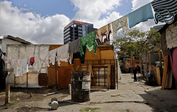 epa07325345 View of parking lot where people live in the popular neighborhood of Petare, in Caracas, Venezuela, 26 January 2019 (issued 27 January 2019). Thousands of Venezuelans, remain living in pov ...