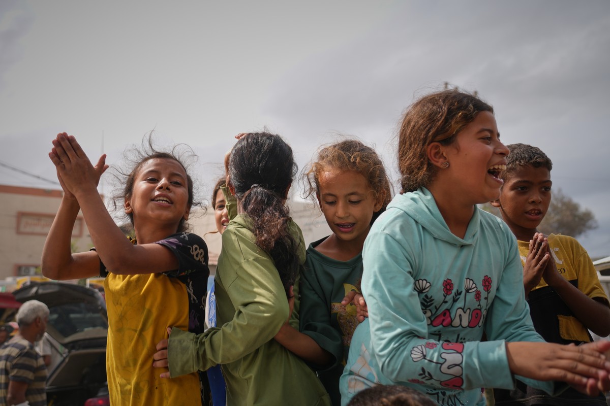 Palestinians celebrate following the announcement that Israel and Hamas have agreed to the first phase of a peace plan to pause the fighting, in Khan Younis, southern Gaza Strip, Thursday, Oct. 9, 202 ...