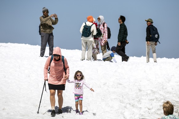 epa07674787 Tourists enjoy the summer temperatures on the Titlis mountain, near Engelberg, Switzerland, 26 June 2019. Europe is bracing itself for a heatwave, as forcasters predict temperatures are ex ...