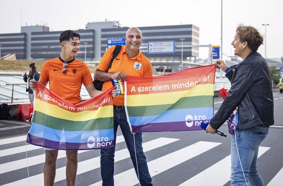 epa09304895 Dutch presenter Klaas van Kruistum hands football fans rainbow flags during recordings for the TV program &#039;Klaas anything is possible,&#039; at Amsterdam Airport Schiphol, near Amster ...