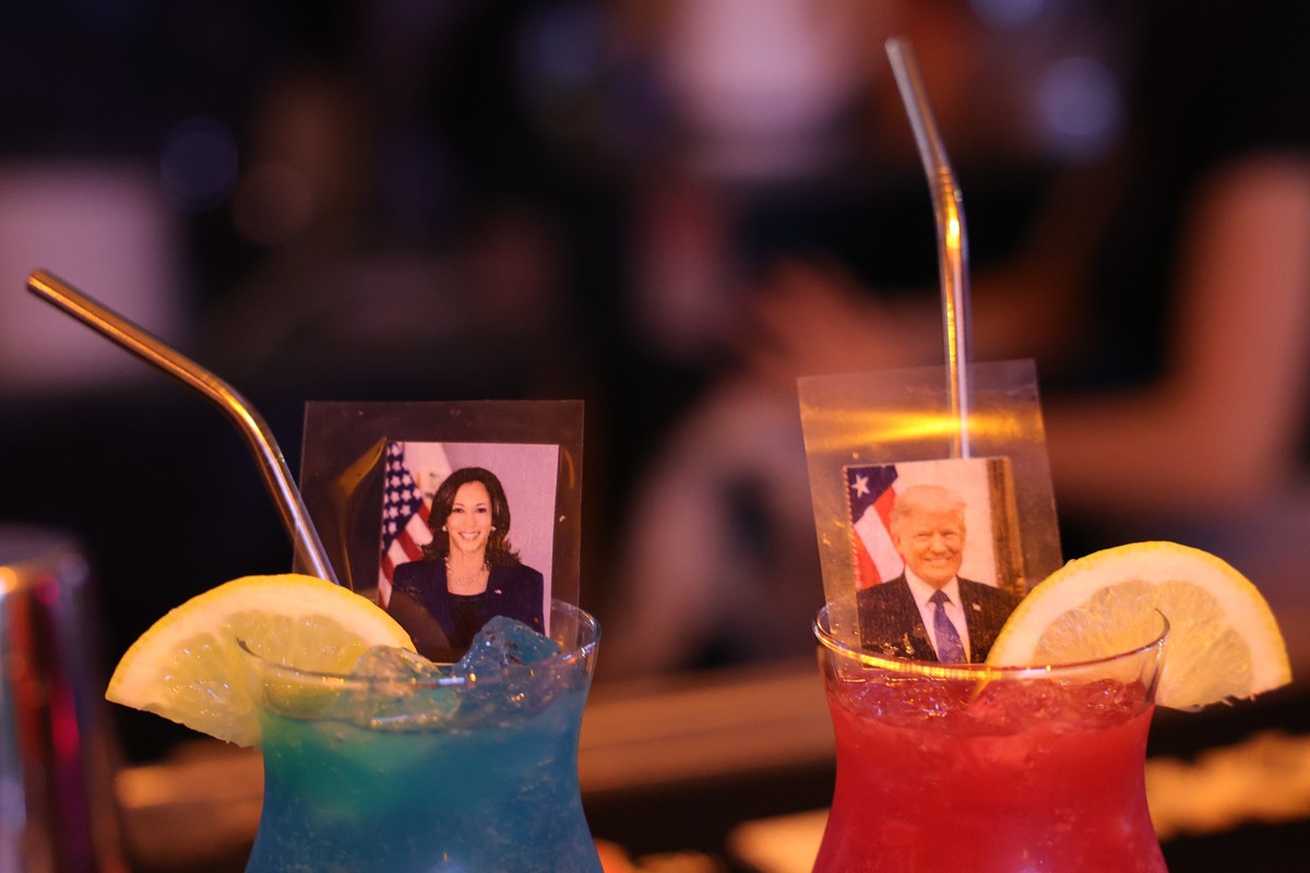 epa11704146 A bartender displays cocktails with pictures of US Republican presidential candidate Donald Trump and Democratic candidate Kamala Harris as Israeli-American citizens gather to watch the po ...