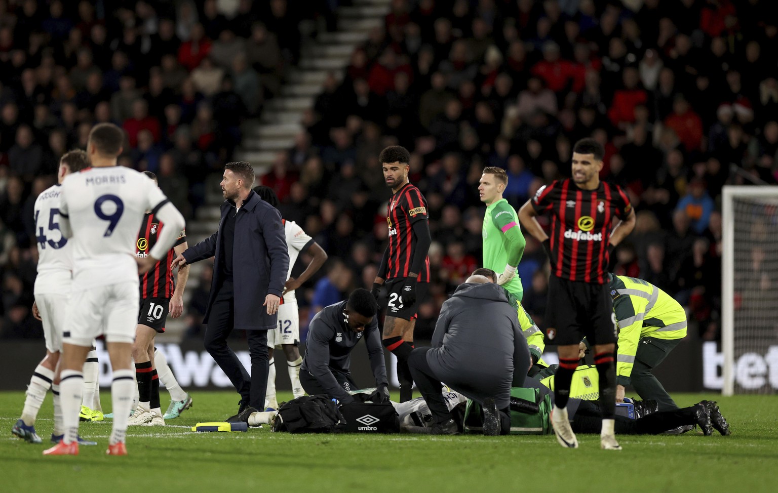 Luton Town manager Rob Edwards on the pitch as his player Tom Lockyer receives treatment during the English Premier League soccer match between Bournemouth and Luton Town at the Vitality Stadium, in B ...