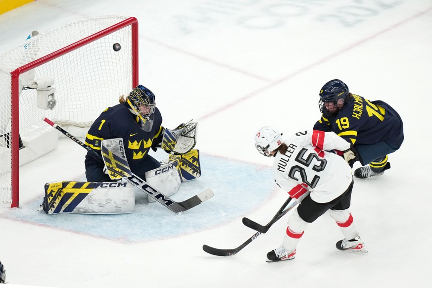Switzerland's Alina Muller (25) scores the winning goal against Sweden goalkeeper Ebba Svensson Traff (1) during the overtime period of the women's ice hockey bronze medal game at the 2026 W ...