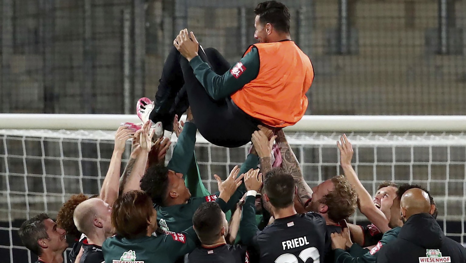 Werder Bremen&#039;s Claudio Pizarro is thrown into the air by his teammates after the end of the game against Heidenheim after the relegation return match during their German Biunesliga soccer match  ...