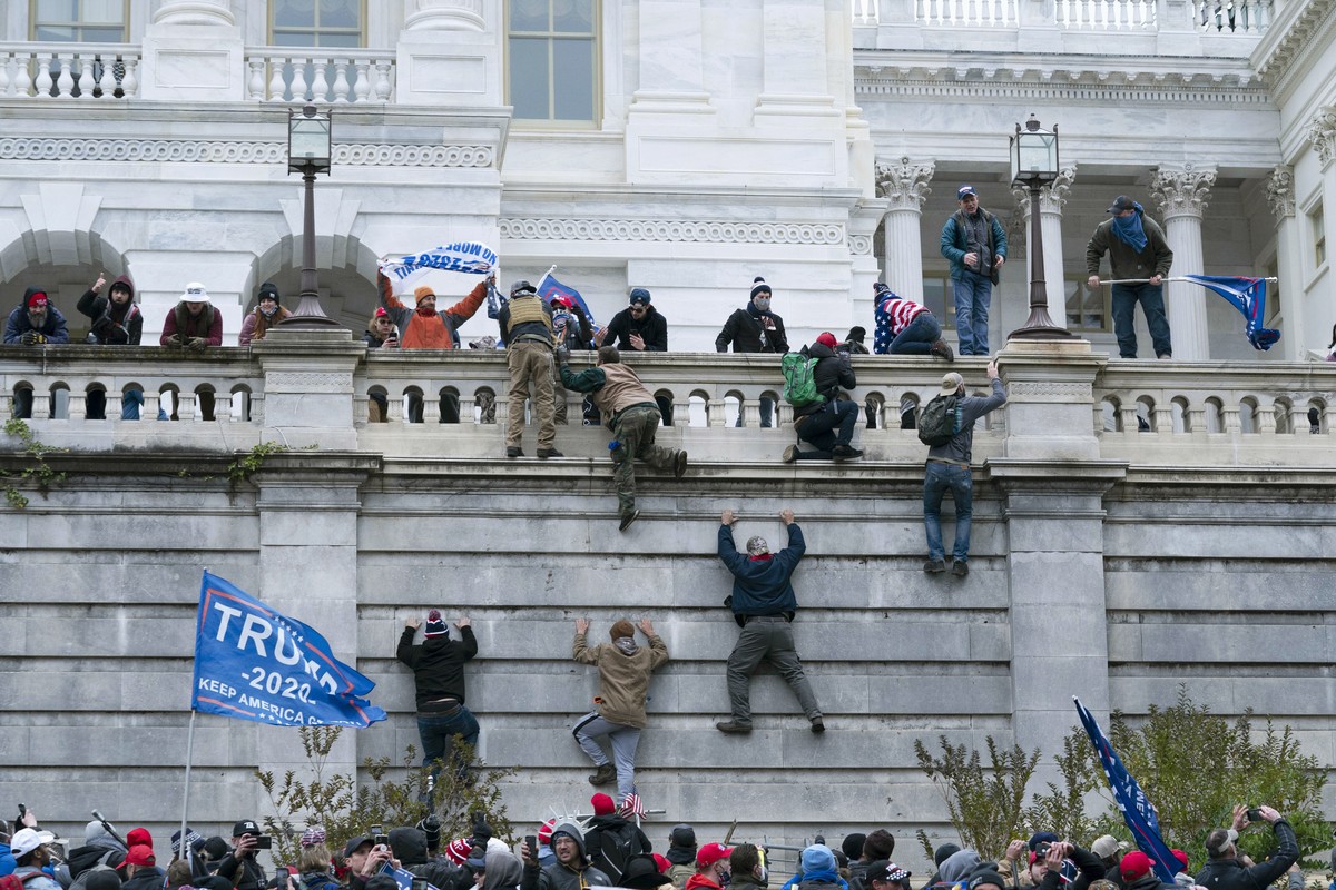 FILE - Violent insurrectionists loyal to then President Donald Trump climb the west wall of the the U.S. Capitol in Washington, Jan. 6, 2021. The House committee investigating the Jan. 6 insurrection  ...