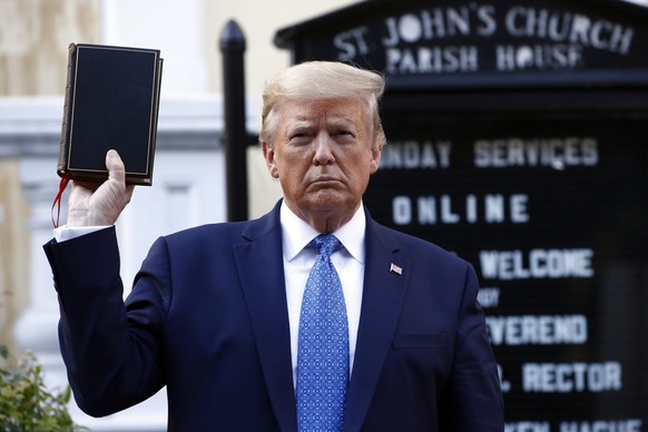 President Donald Trump holds a Bible as he visits outside St. John&#039;s Church across Lafayette Park from the White House Monday, June 1, 2020, in Washington. Part of the church was set on fire duri ...