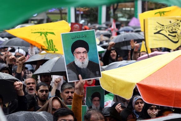 epa11630360 A protester holds a picture of late Hezbollah leader Hassan Nasrallah during an anti-Israel protest in Palestine Square in Tehran, Iran, 28 September 2024. The Lebanese militant group Hezb ...